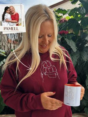 Custom embroidered hoodies featuring a woman holding a mug, showcasing a heartfelt design.